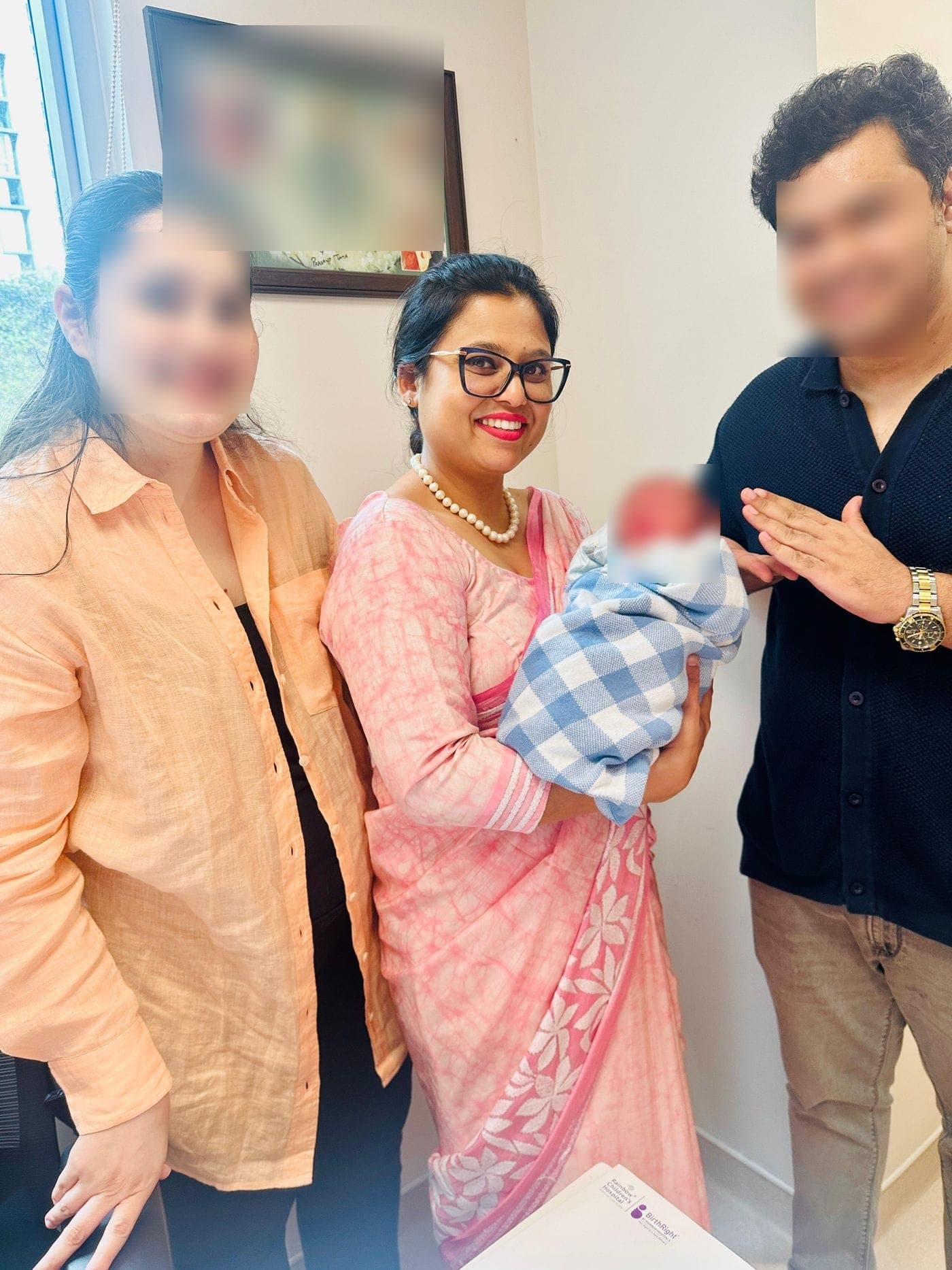 Dr. Nikita with a family and their newborn