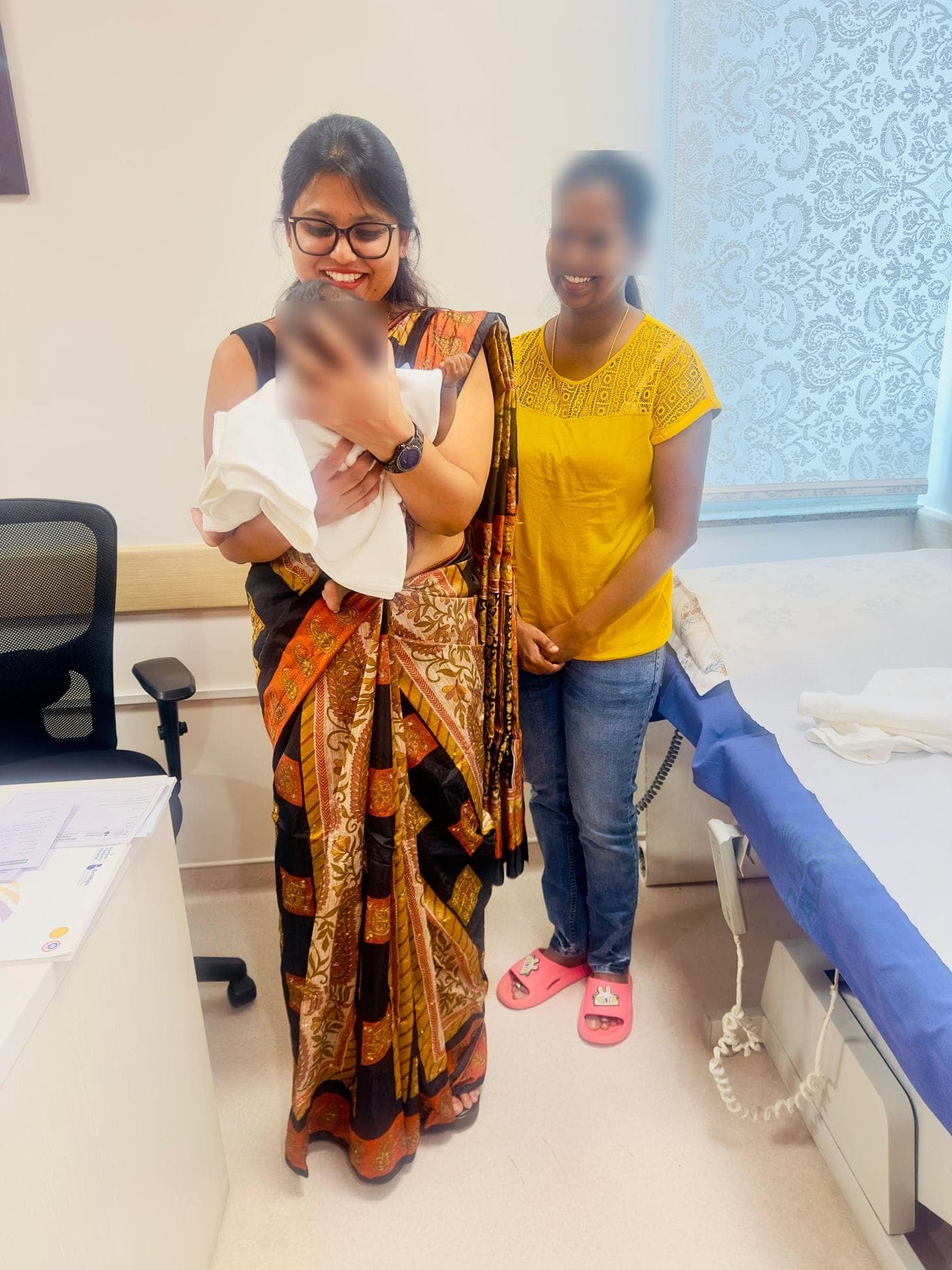 Dr. Nikita holding a newborn at a check-up
