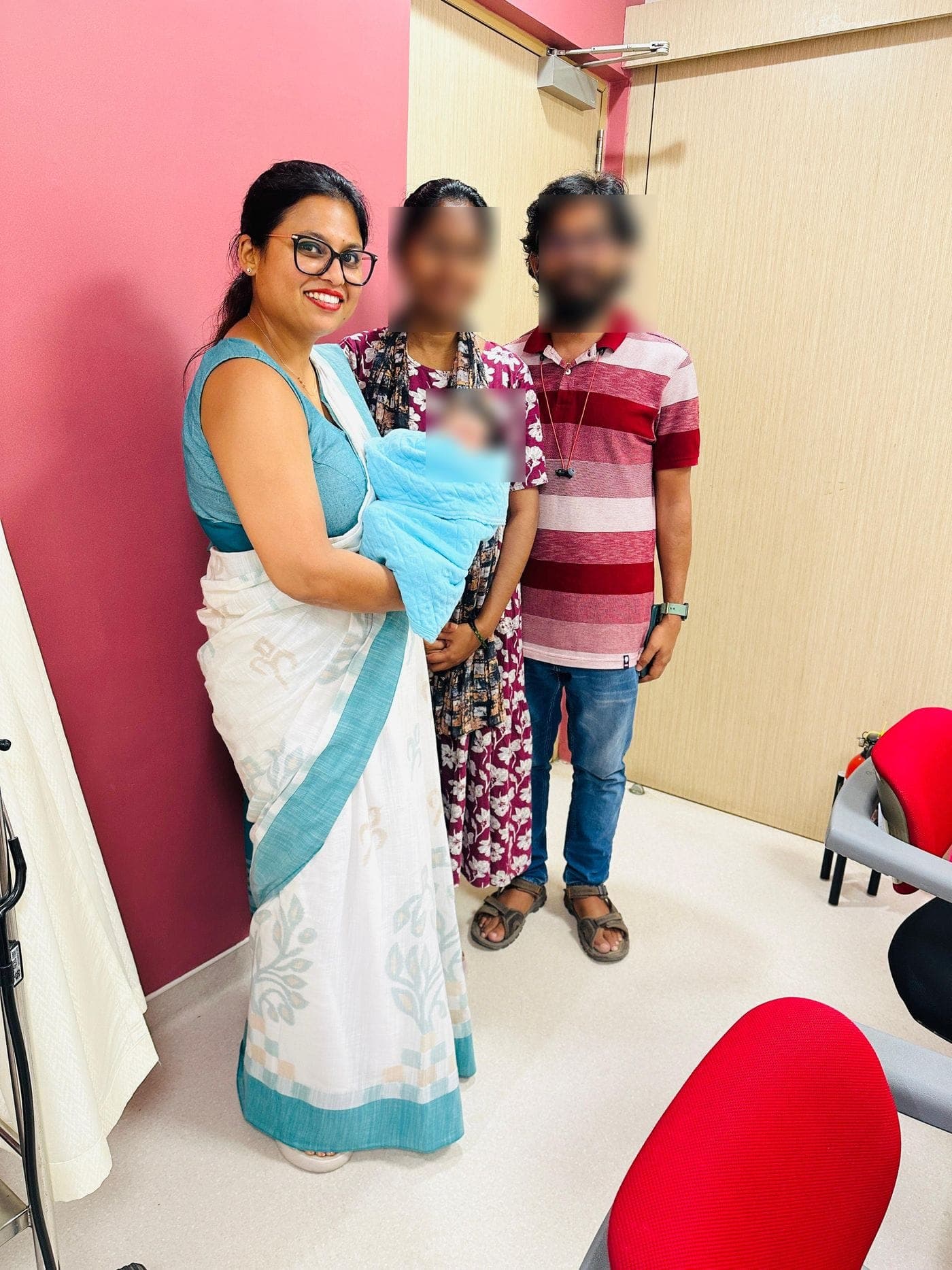 Dr. Nikita with parents and their newborn