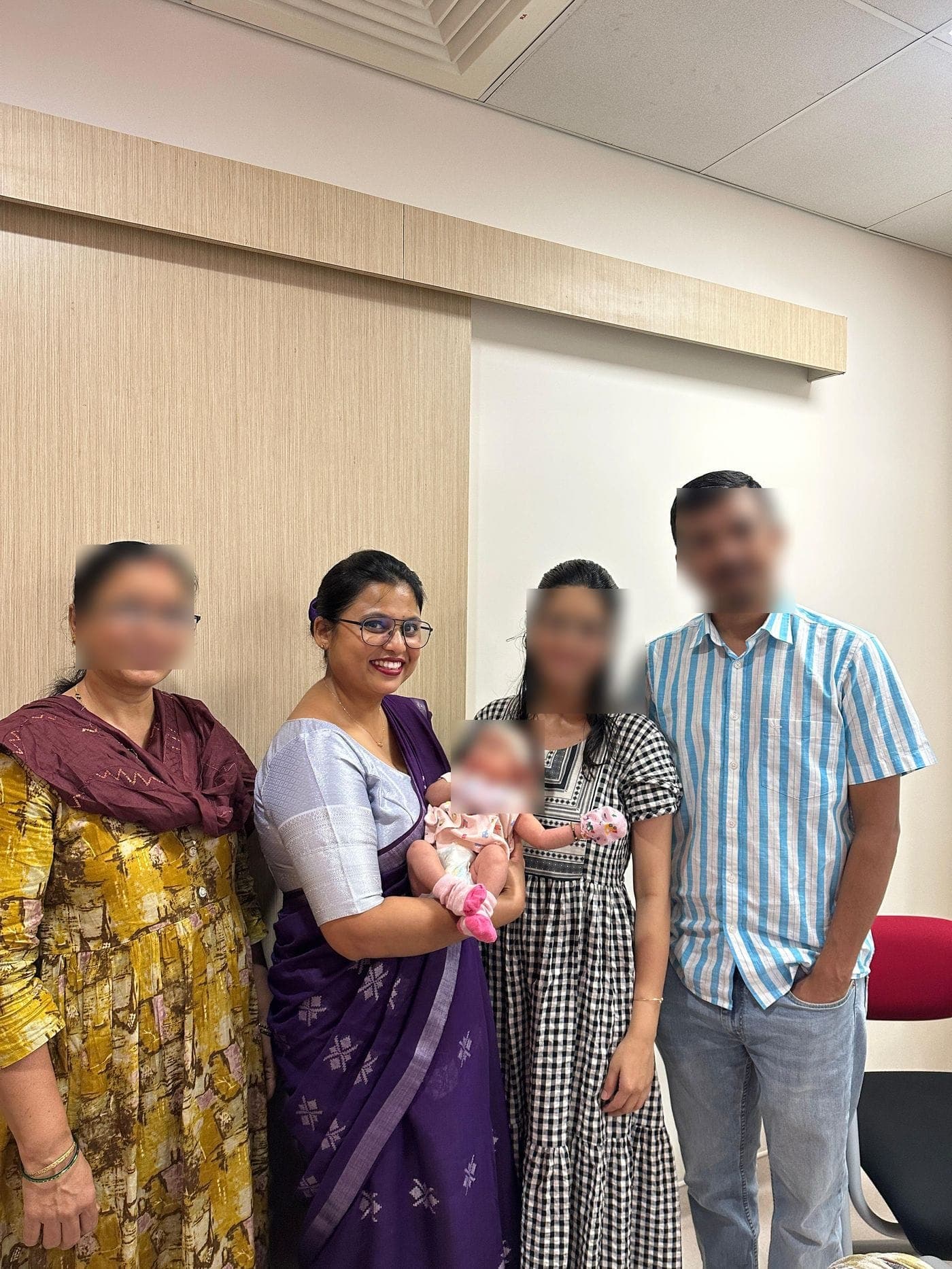 Dr. Nikita with a family and their baby