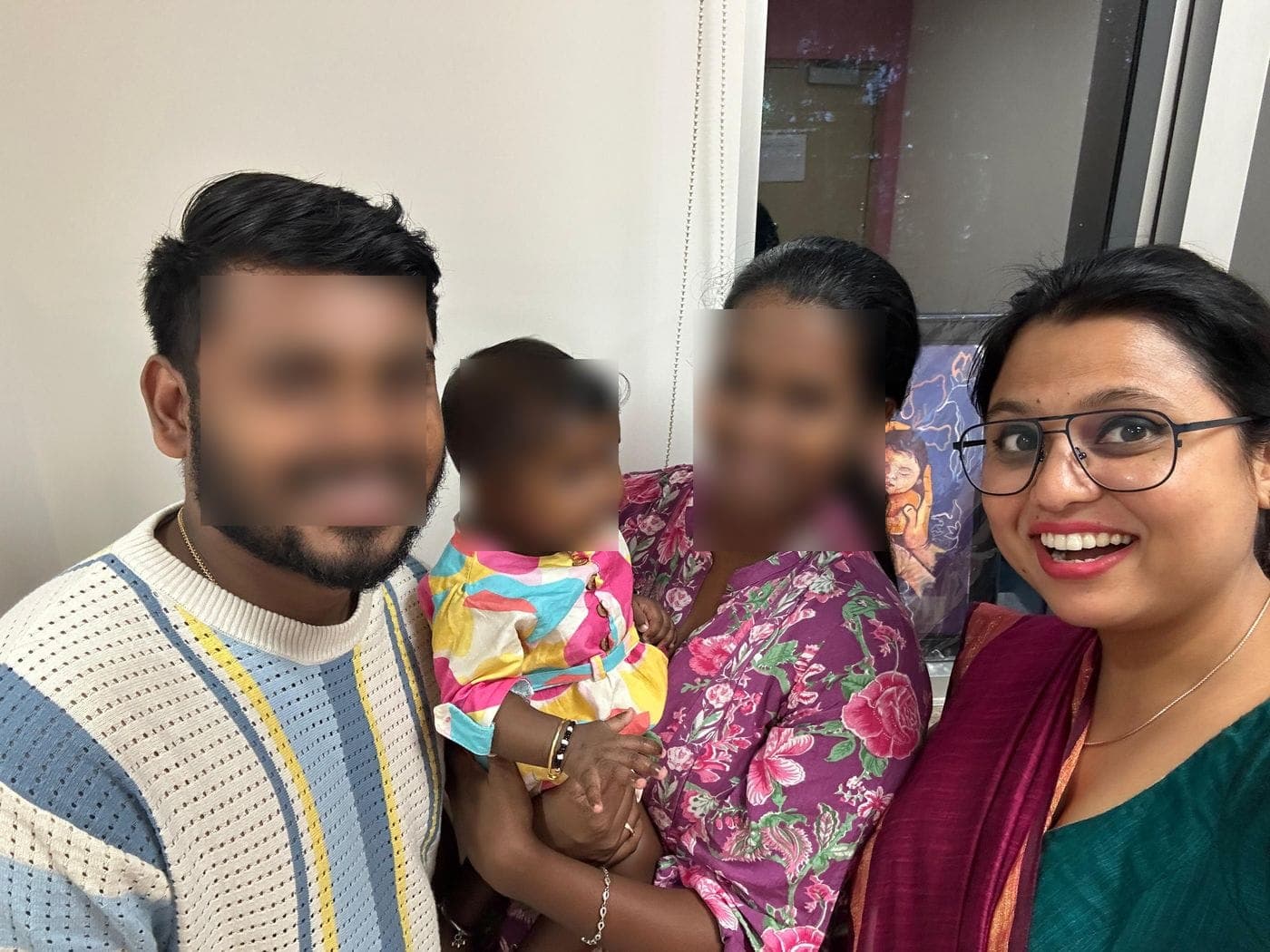 Dr. Nikita with a family at a follow-up visit