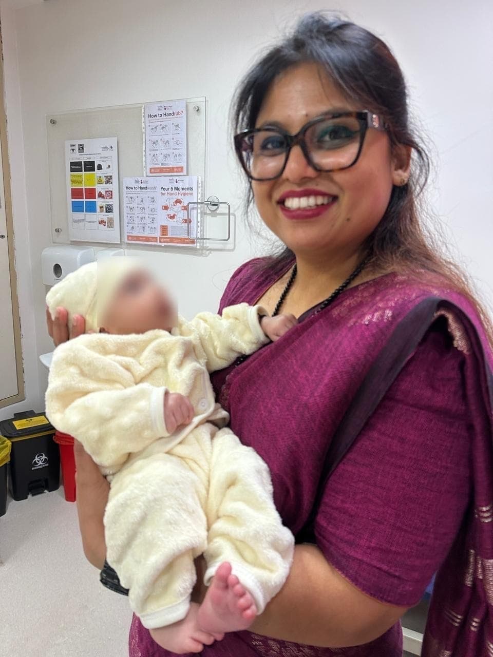 Dr. Nikita holding a newborn at the clinic